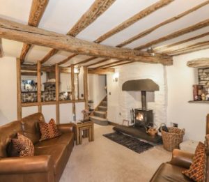 A warm, inviting cottage kitchen featuring local Lake District slate floors and a rustic dining table for family meals.