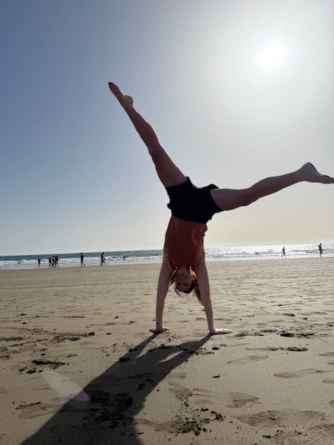 Mummy doing a cartwheel on the beach